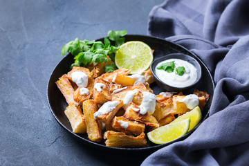 Fried yucca, yuca, cassava, manioca, mandioca with cilantro sauce
