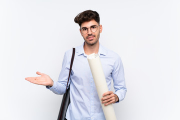 Young architect man over isolated white background holding copyspace imaginary on the palm