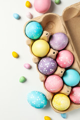 Fototapeta na wymiar Multicolor Easter eggs on white background, top view