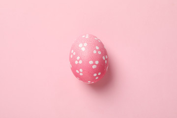 Pink Easter egg on pink background, close up