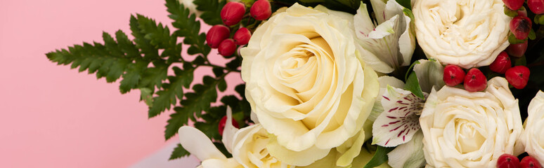 panoramic shot of bouquet of flowers isolated on pink