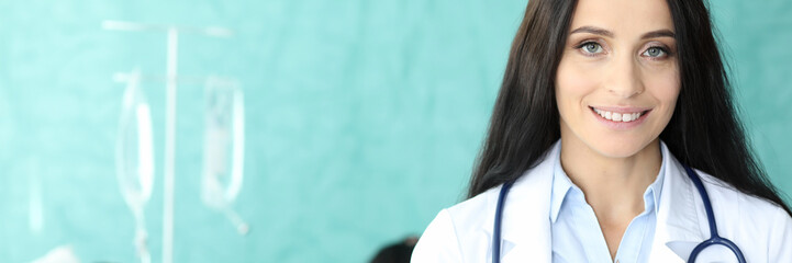 Portrait of lovely doctor holding paper folder. Cute lady writing appointment to sick patient. Dropper dripping to ill male. Healthcare and medicine concept