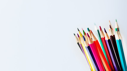 Fototapeta premium Colorful pencils on white wooden background. Education concept.