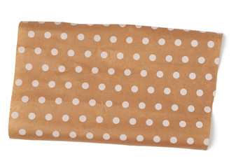 piece of brown paper with white polka dots isolated on a white background
