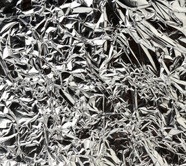 texture of shiny crumpled piece of gray foil, packaging material
