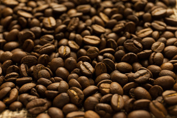 Roasted Arabica beans close up, coffee background