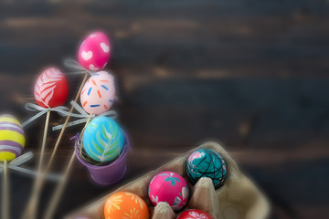 groups of colorful easter eggs in the basket on the wooden table preparing for cerebrating the event (blurred picture)
