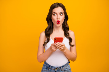 Photo of pretty shocked lady speechless hold telephone hands open mouth look side empty space...