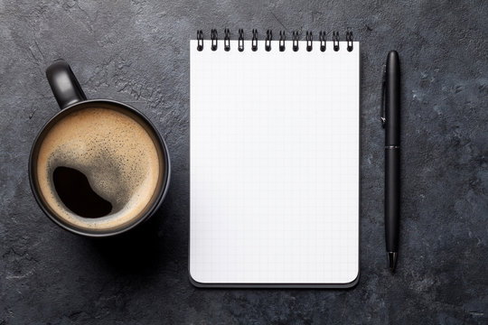 Office desk table with notepad and coffee