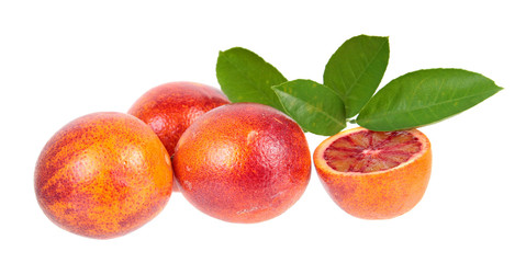 Composition with sliced and unpeeled ripe blood orange with green leaves isolated on white background