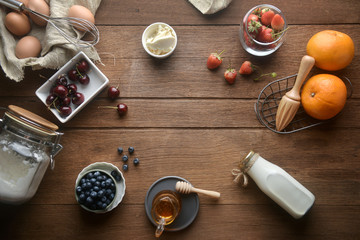 Ingredients for dessert, pancakes, cake, baking on a wooden background. top view.