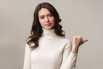 Photo of caucasian woman frowning and gesturing at copyspace