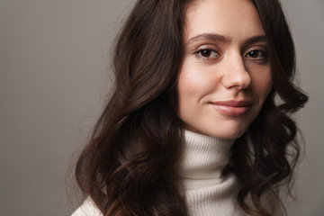 Photo of caucasian happy woman with long brown hair smiling at camera