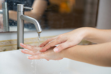 The beautiful female hand that applying soap in the sink from or anti-bacteria to prevent the spread of germs at white background