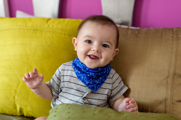 Small, smiling baby sitting