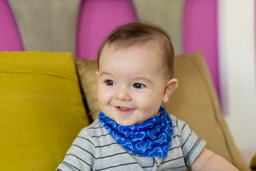 Small, smiling baby sitting