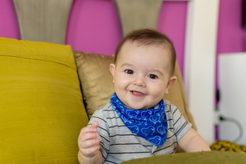 Small, smiling baby sitting