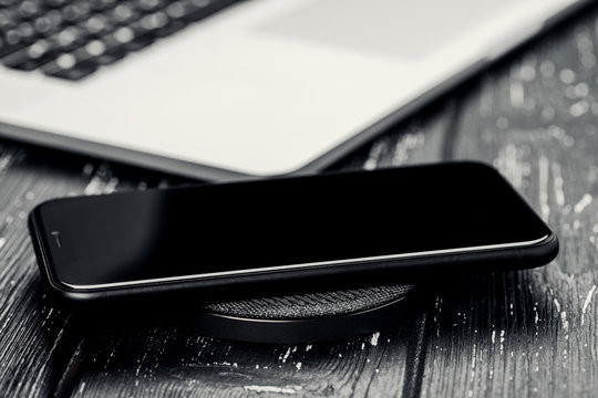 Close-up Phone Charging On Wireless Charger Device.