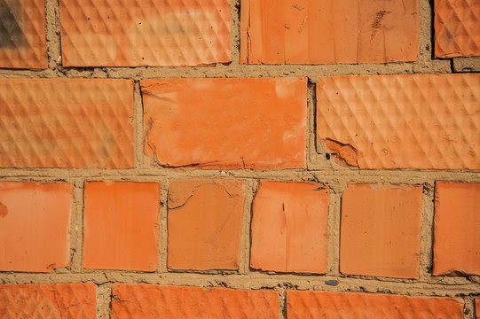 Fototapeta texture of an old red brick wall,the rough texture of the brickwork,the surface of red bricks with the seams of the concrete