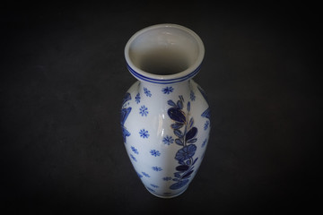 blue ceramic vase on black background