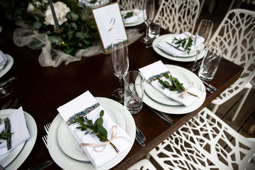White napkin with eucalyptus and guest card on it