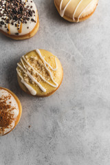 donuts with icing on grey background