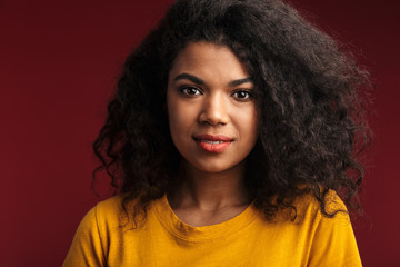 Image of beautiful brunette african american woman with curly hair smiling