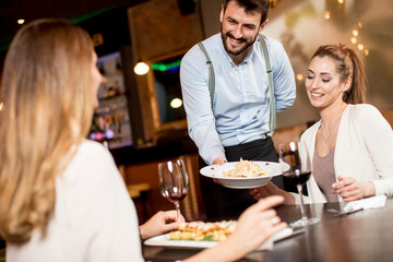 The waiter carries dishes