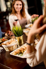 Two young women at a dinner  in a restaurant