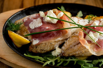 Sea bream stuffed with cream cheese and smoked ham with young potatoes and leek