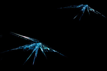 a crack on a broken glass mirror , on a black background in the form of an abstraction as a drawing...