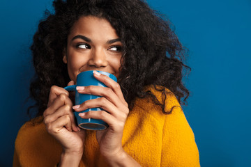 African woman posing isolated over blue wall