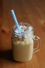 Hot chocolate or cocoa with marshmallows, on wooden table, on kitchen