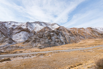 Fototapeta na wymiar the gravel road on the snow mountain