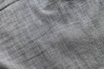 Heavy used blue grey jean denim top view close up shot to the detail of fabric. textile material and cotton patter tough and durable garment style. For background or wallpaper with copy space for text