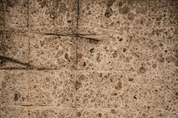 background of a stone wall with rebar, background sand wall with stones and rust,