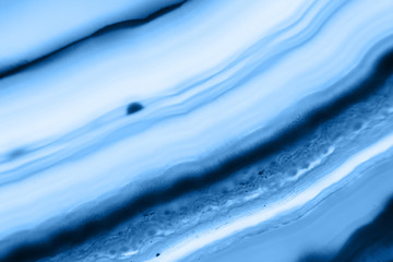 Abstract background - striped agate slice mineral, color of the year 2020 pantone classic blue 19-4052
