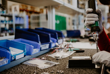 Digital computer PC technology and electronic industry manufacturing and production business concept: macro view of the CPU processor in hand in gloves in the electronic laboratory