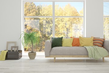 Stylish living room in white color with sofa and autumn landscape in window. Scandinavian interior design. 3D illustration