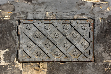 Black forged door, rhombus symmetrical texture. Grunge black background