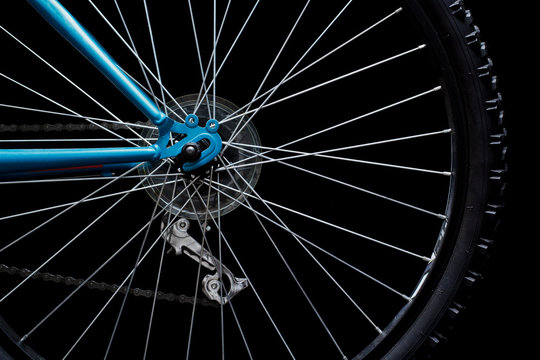 Rear bicycle wheel on black. Low key image.