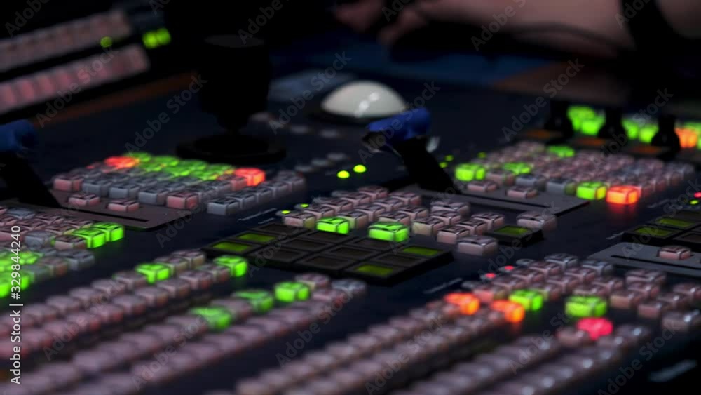 Poster close up of lit lights of different buttons on the control panel and the controller male hand. stock