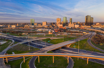 Aerial panorama picture of the Fort Worth skyline at sunrise with highway intersection in Texas