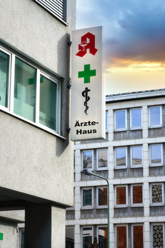 Frankfurt,Germany, : Pharmacy logo, green cross and aesculapius symbol on a facade in Frankfurt