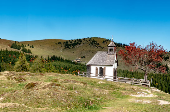 Autumn landscape, Styria, Austria - The old beautiful chapel on the Postalm, on an autumn day in golden October with blue sky.