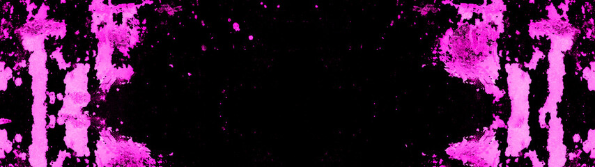 Frame of pink neon painted abstract speckled splashes of color isolated on black background banner...
