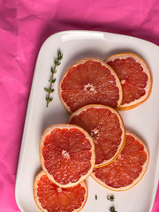 Fototapeta na wymiar red grapefruit sliced on the kitchen table.