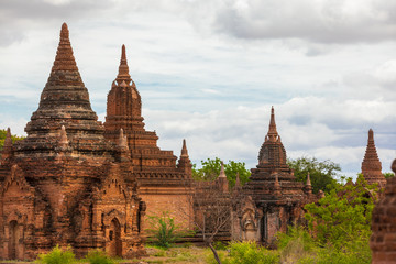 Buddhist pagoda temple. Bagan, Myanmar. Home of the largest and denset concentration of religion Buddhist temples, pagodas, stupas and ruins in the world. Blue sky with clouds.