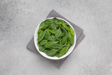 Fresh spinach leaves in bowl. Top view. 