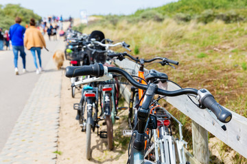 Fototapeta na wymiar parked bicycles ahead of dunes at the Northern Sea in the Netherlands